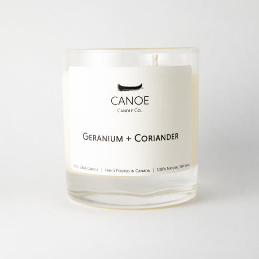 Canoe Candle Co.’s Geranium + Coriander 10oz soy wax candle on a plain white background.