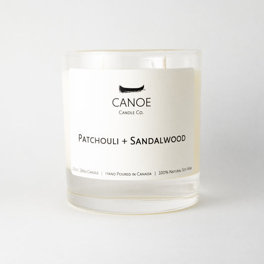 Canoe Candle Co.’s Patchouli + Sandalwood 10oz soy wax candle on a plain white background.