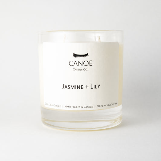 Canoe Candle Co.’s Jasmine + Lily 10oz soy wax candle on a plain white background.