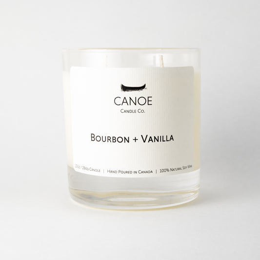 Canoe Candle Co.’s Bourbon + Vanilla 10oz soy wax candle on a plain white background.